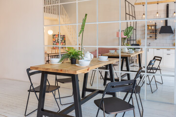 luxury modern design of a cozy small Scandinavian-style studio apartment with white walls, second floor with a library and huge high window full of day light