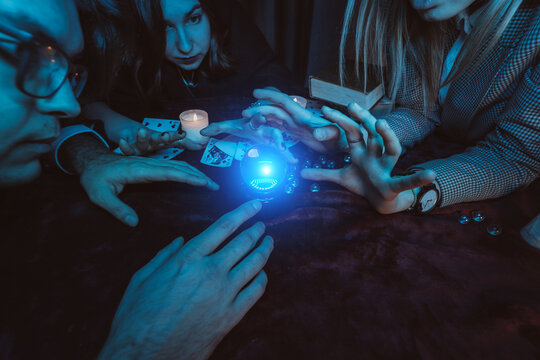 Group of people and woman fortune teller with crystal ball