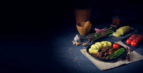 dumplings with beef goulash and green asparagus
