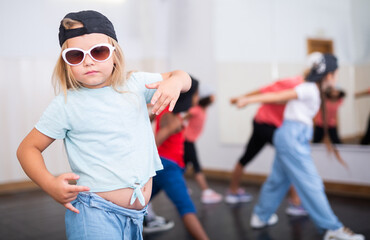 Girl hip hop dancer posing at class