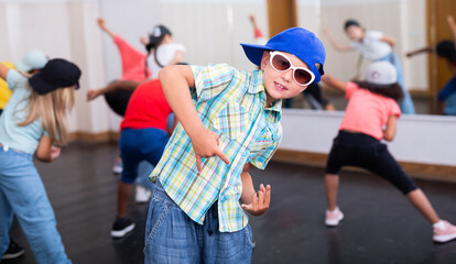 Boy hip-hop dancer posing at studio