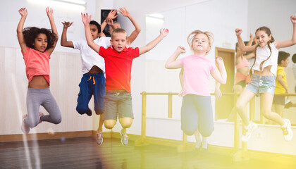 Boys and girls jumping in dance studio
