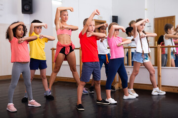 Fototapeta na wymiar Boys and girls training in dance studio