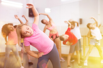 Girl exercising in group during dance class