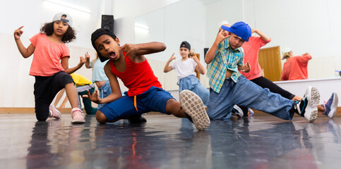 Kids hip hop dancers posing in studio