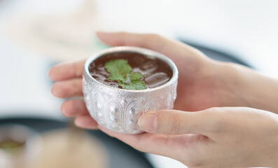 Hotel welcome drink, herbal tea in Silver bowl handicrafts Thailand northern style call "Salung Ngern".