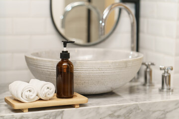 Hygiene concept. Towel and soap at sink in bathroom.