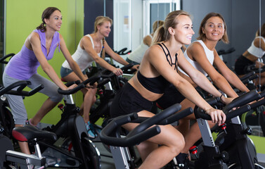 Fototapeta na wymiar women on cardio training on exercycles in health club