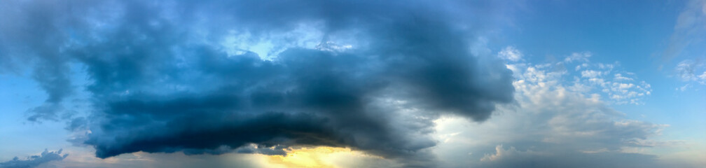 Stormy stormy sky with clouds at sunset, banner, panorama.
