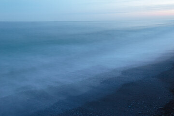Sea tide at sunrise, light misty breeze