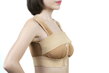 Woman posing in support bra after breast augmentation plastic surgery with silicone breast implants.