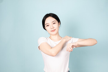 A young chinese woman in front of blue background