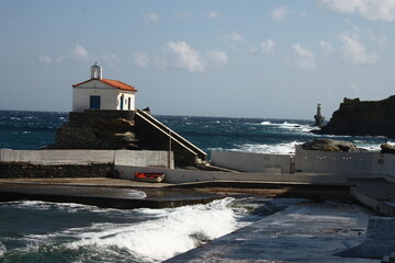 Waves at the small harbour in front of the Chapel of Panagia Thalassini at Andros, Greece 