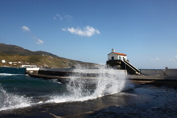 Waves at the small harbour in front of the Chapel of Panagia Thalassini at Andros, Greece 