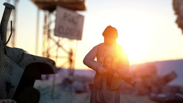 Man terrorist wearing a mask and holding a gun. East desert landscape. military headquarters, terrorist base.