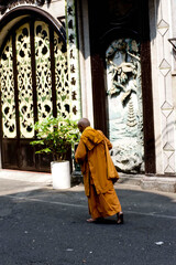zen monk walking barefoot in the streets of vietnam