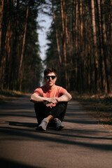 Obraz premium Handsome young man outdoor in park, walking in the park