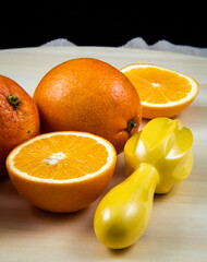 A close-up photo of chopped lemons and oranges on a black background.