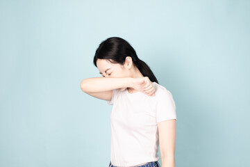 A young chinese woman in front of blue background