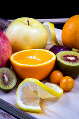 Sweet and sour fruits in one frame, such as kiwi, cantaloupe, pineapple, strawberry and orange.