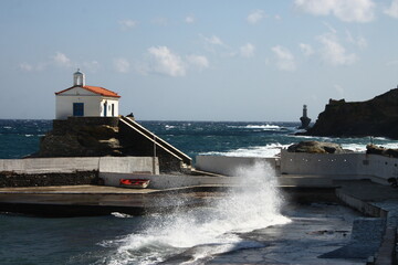 Waves at the small harbour in front of the Chapel of Panagia Thalassini at Andros, Greece 