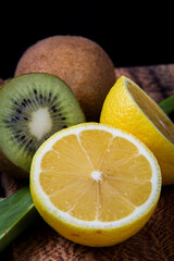 A close-up photo of thin slices of lemon and kiwi together.