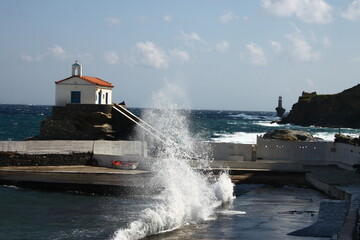 Waves at the small harbour in front of the Chapel of Panagia Thalassini at Andros, Greece 