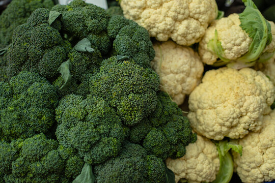 Close Up Of Pile Cauliflower And Broccoli At The Farmers Market. Market And Trade Concept