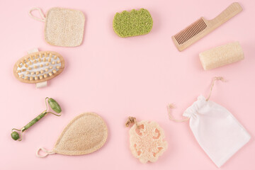 Spa, zero waste composition on pink background. Wellness layout with hairbrush, bamboo toothbrush, loofah, sponge, bag. Sustainable lifestyle flat lay. Skin care, body treatment, beauty concept
