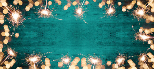 Frame of lights bokeh lights flares and sparkler isolated on Abstract turquoise painted wooden...