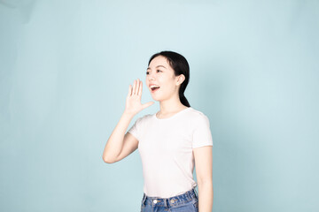 A young chinese woman in front of blue background