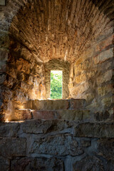 Medieval cellar window with sunlight coming in from the outside