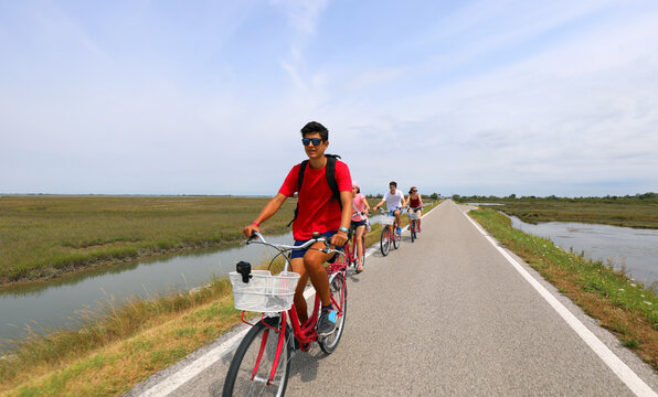 family cycling pedals on the bike path near Venice