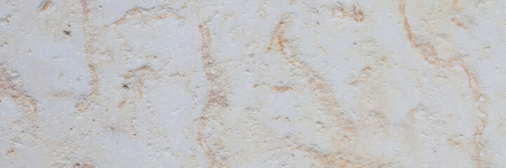 Dolomite texture. Natural rock with beautiful beige patterns on the surface. Polished flat stone. Classic luxury decoration building material. Wide panoramic texture for background and design.