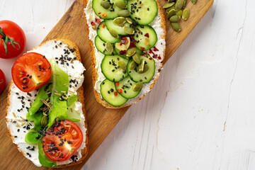 Sandwiches with cheese feta, cucumber slices and cherry tomatoes. View from above