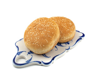 sesame buns for hot dogs on a white isolated background, close-up