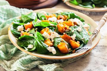 Roasted pumpkin salad with spinach and nuts
