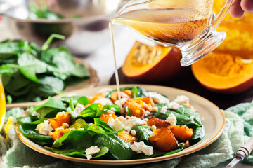 Roasted pumpkin salad with spinach and nuts