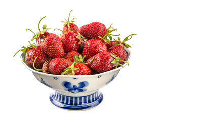 ripe strawberries in a plate on a white isolated background close-up