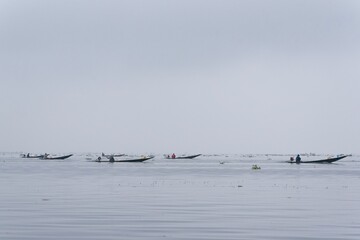 Traditional fisherman on a boat on Inle Lake Myanmar Burma