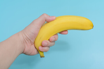 Hand holding a banana.