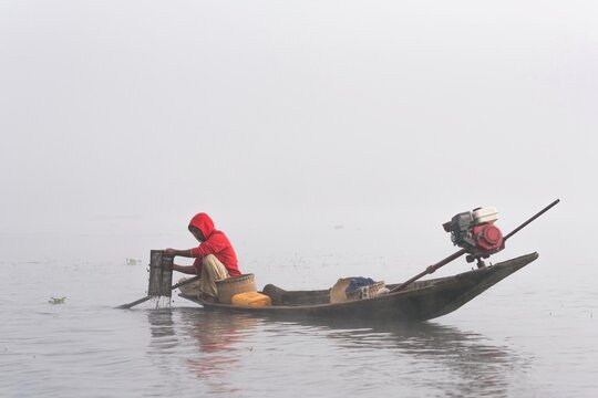 Traditional fisherman on a boat on Inle Lake Myanmar Burma