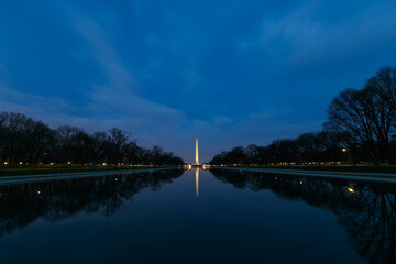Fototapeta na wymiar Washington Monument is reflected in the Mirror Pond in Washington DC in the evening