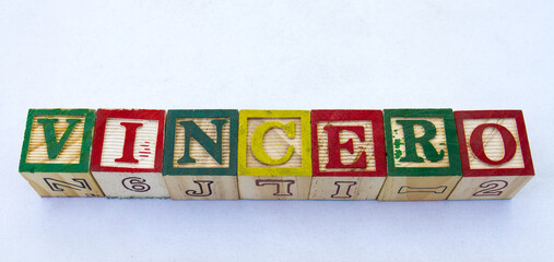The term vincero displayed visually on a clear background using colorful wooden blocks image with...