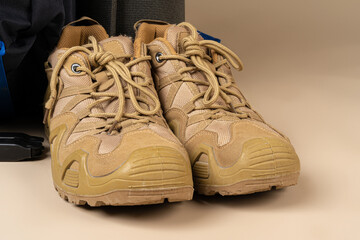 Blue backpack and hiking boots. Mountain gear close up