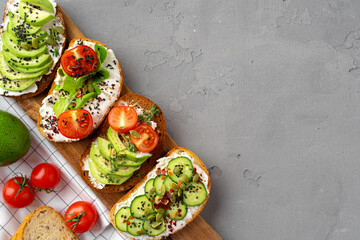 Assortment of vegan sandwiches with avocado and tomatoes