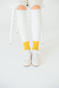 pop of yellow socks with whit ripped jeans