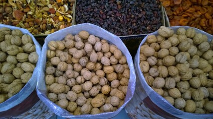 Walnuts and dried fruits for sale in the grocery local farmer market. Nuts for healthy fitness super food. Natural organic product concept. Agricultural fair. 