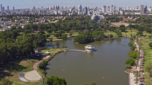 Flying above park "Leumi" in Israel with a distant view on Tel Aviv business skyline, 4k aerial drone footage