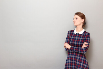 Portrait of resentful girl with head turned away, holding arms folded